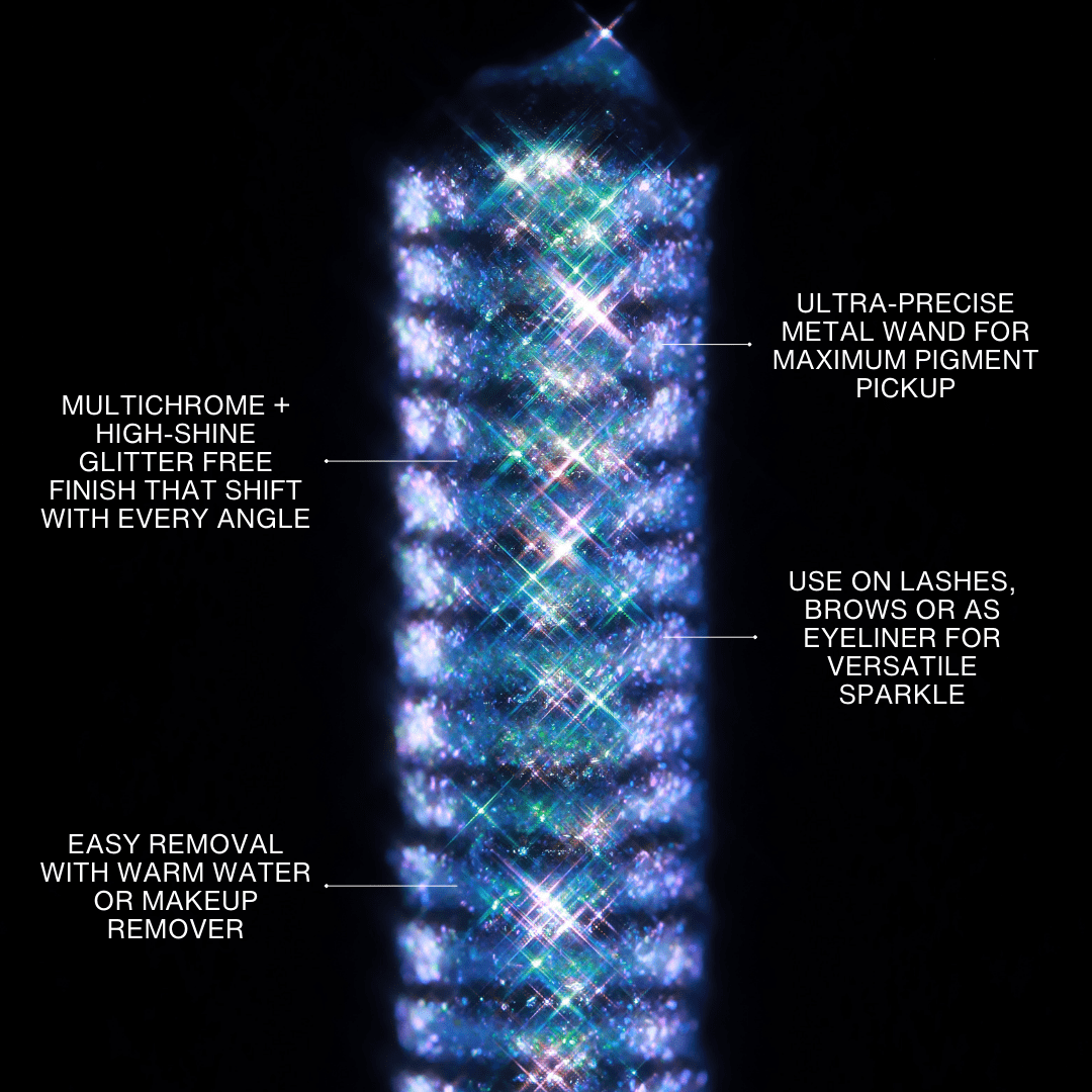 A multichrome mascara applicator with iridescent shimmer rests on a black background.