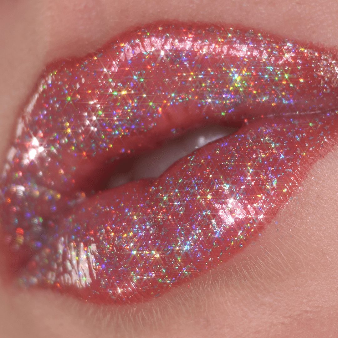 A close-up of lips with multicolored sparkles and a shiny holographic finish.