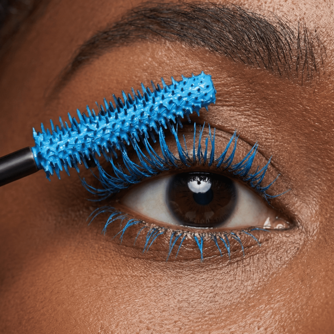 Close-up of an eye with blue mascara applied to the upper lashes