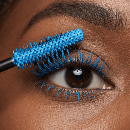 Close-up of an eye with blue mascara applied to the upper lashes