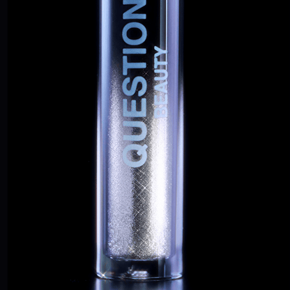 A silver mascara topper labeled Question Beauty rests against a plain black background.