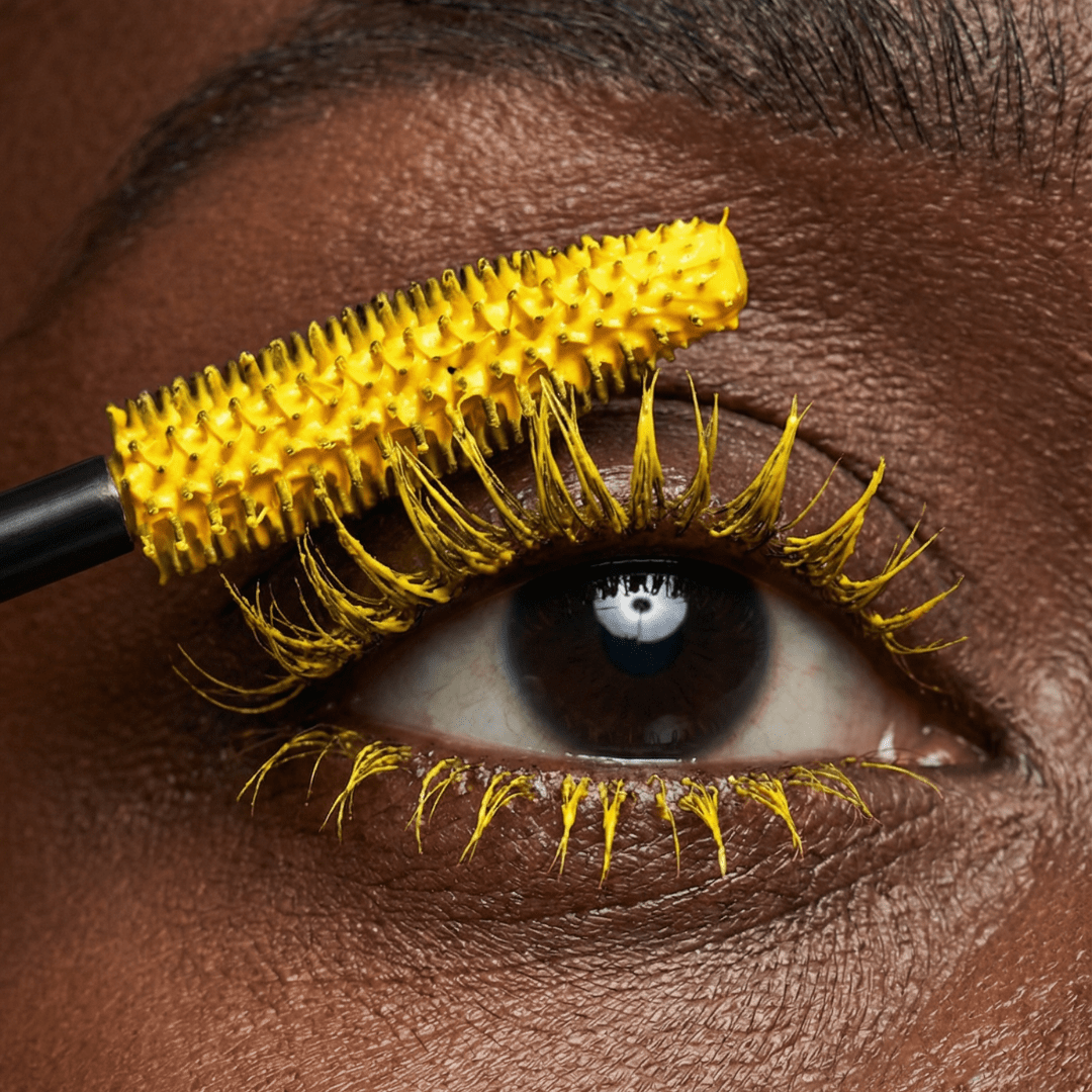 A close-up shows a wand applying orange mascara to upper lashes labeled Mascara - Solar Flare.
