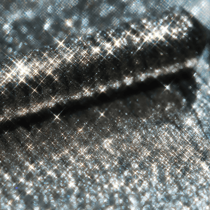 Close-up of a mascara with a shiny metallic silver finish and subtle sparkling reflections.