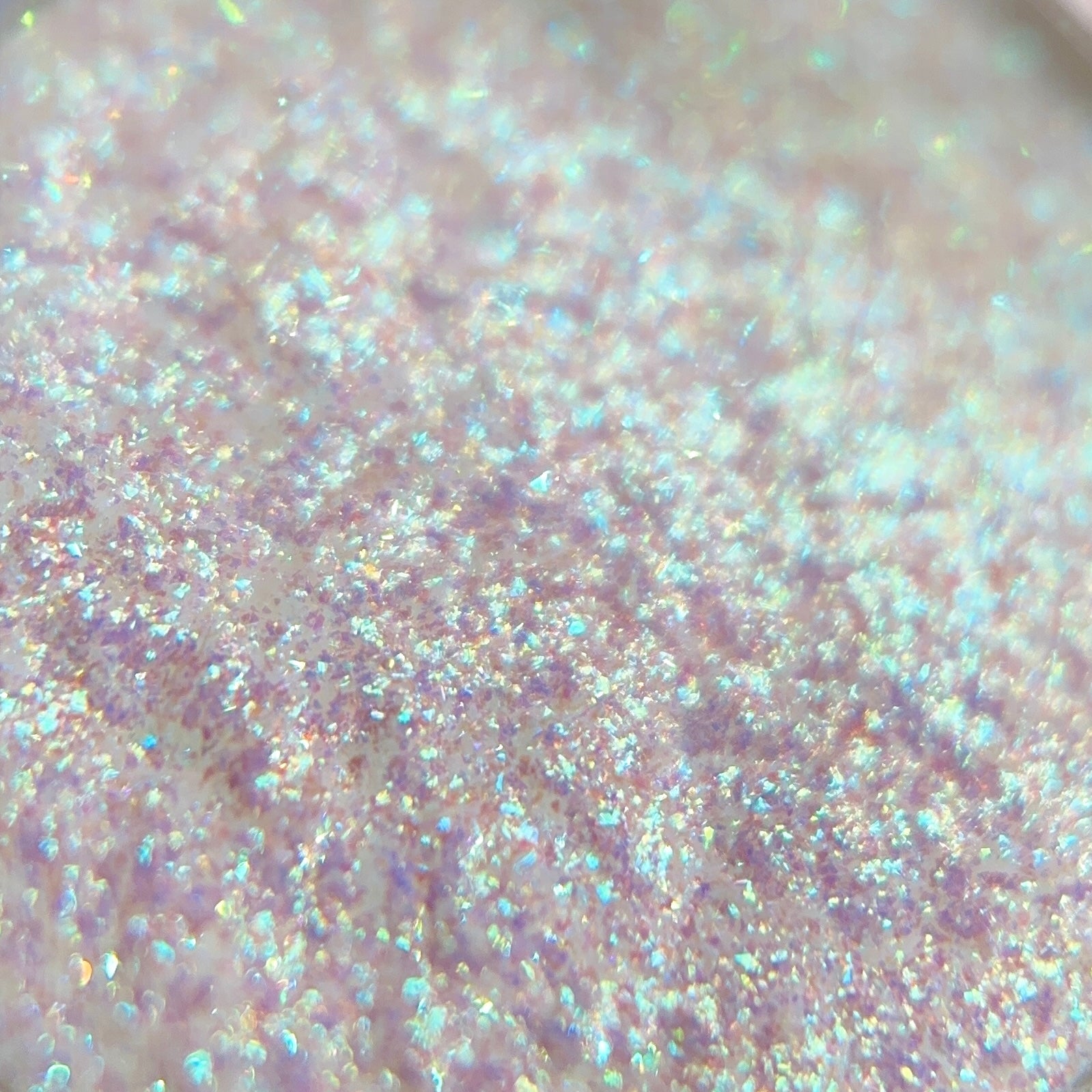 Close-up of  iridescent pink, blue, and purple glitter.