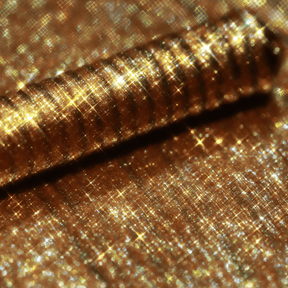 A close-up of an applicator with gold shimmer is shown, highlighting its metallic finish.