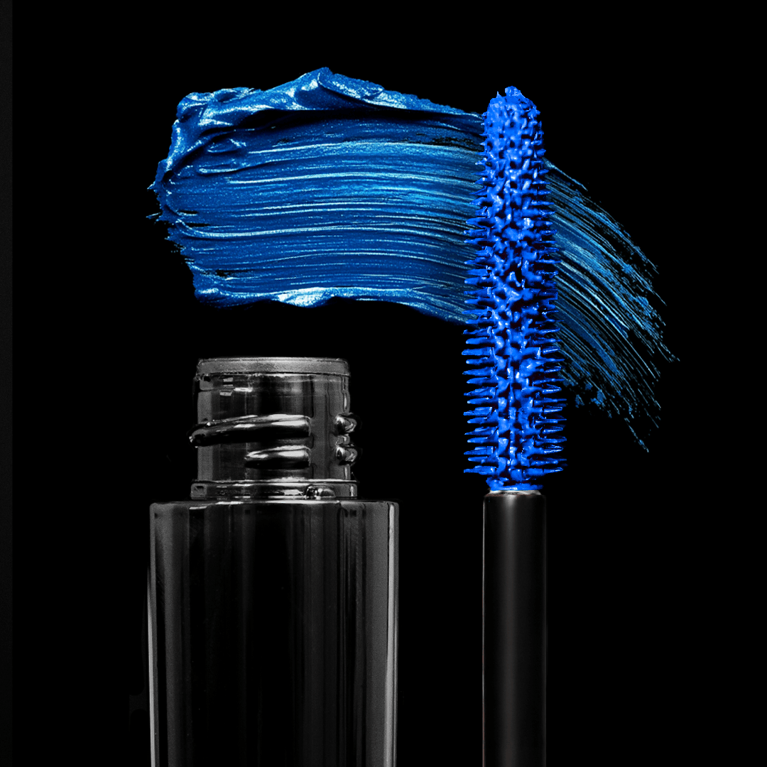 A blue mascara tube and a bold blue swatch are displayed on a black background.